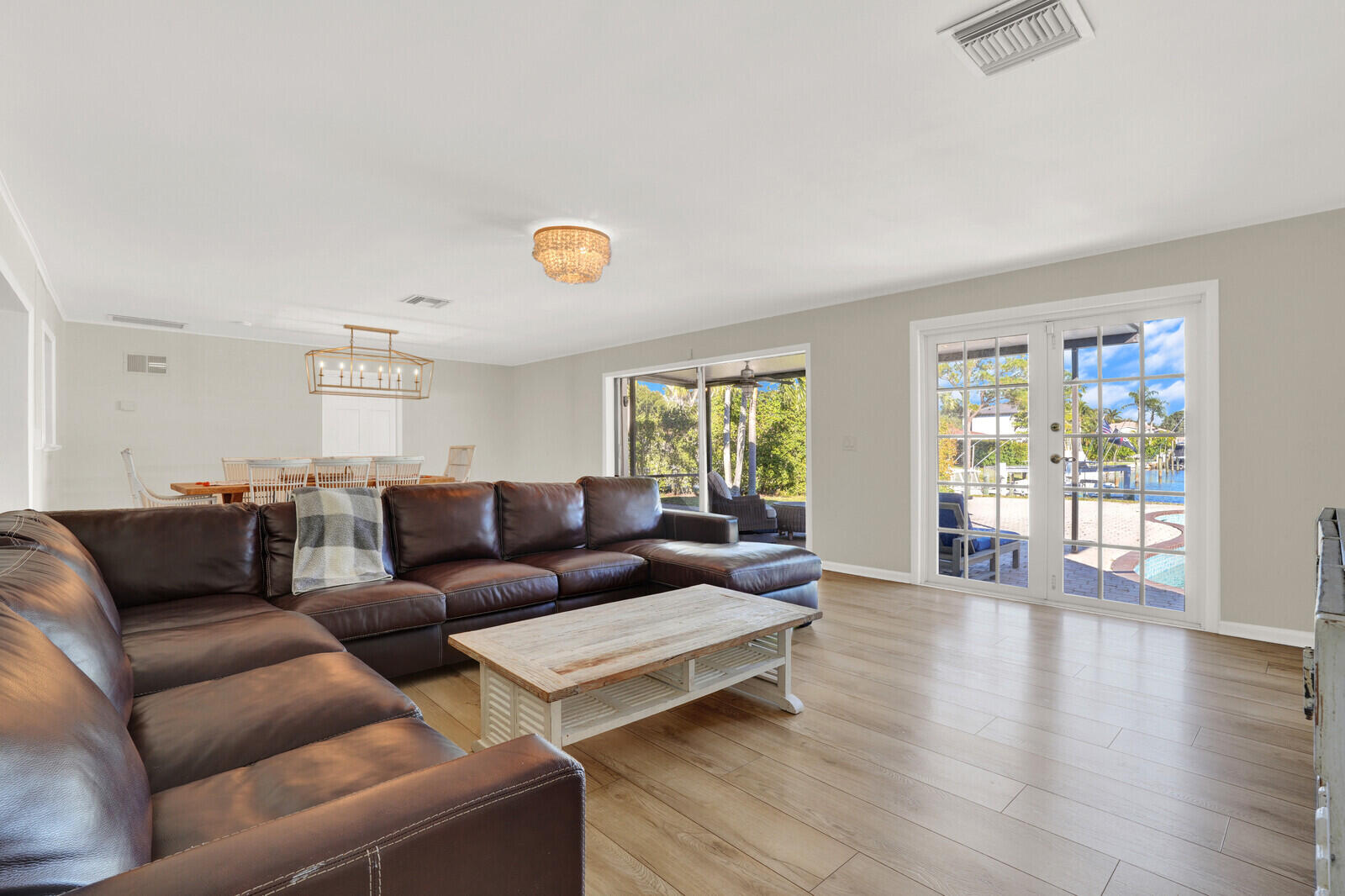 12980 Prosperity Farms Road Palm Beach Gardens, FL 33410 - Photo 21 of 55 a living room with furniture and wooden floor