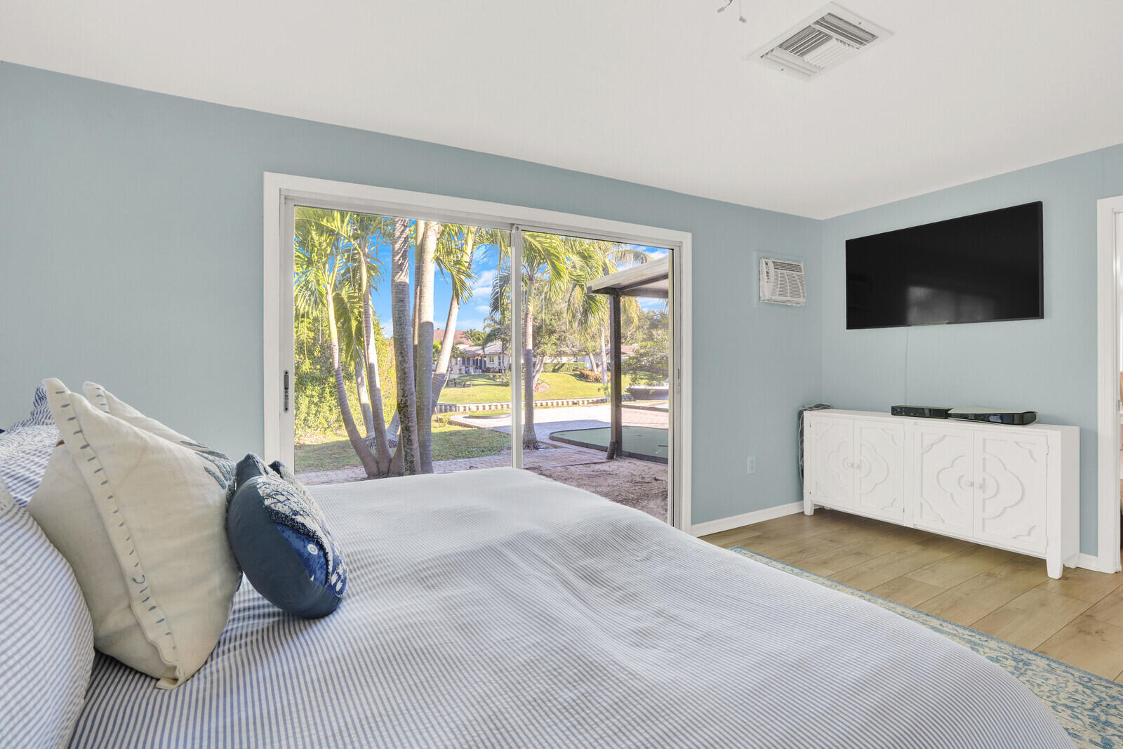 12980 Prosperity Farms Road Palm Beach Gardens, FL 33410 - Photo 24 of 55 a bedroom with a bed and a flat screen tv