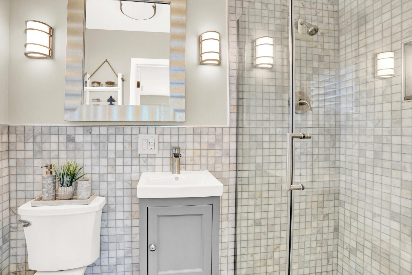 12980 Prosperity Farms Road Palm Beach Gardens, FL 33410 - Photo 35 of 55 a bathroom with a sink a mirror and a shower