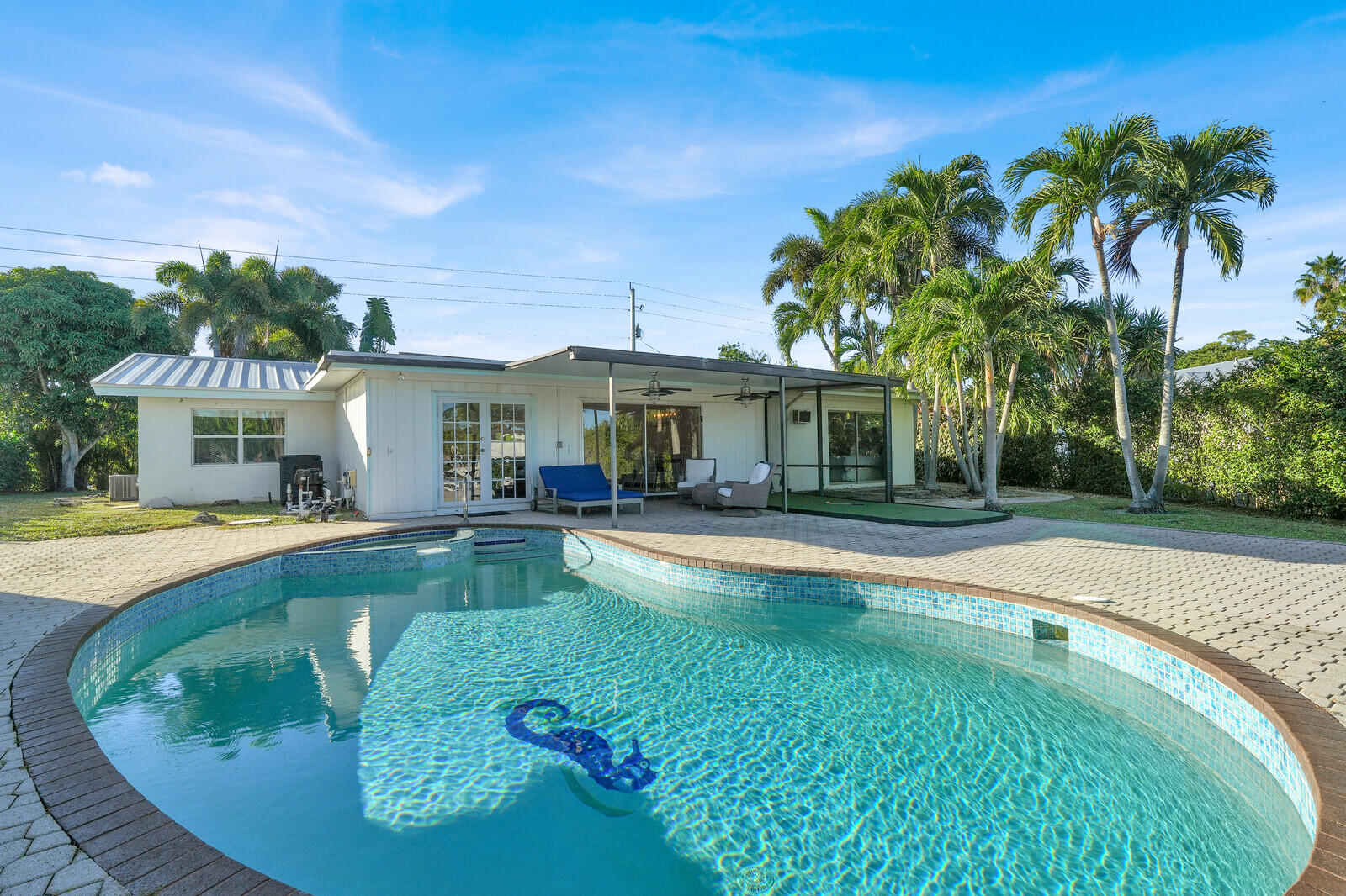 12980 Prosperity Farms Road Palm Beach Gardens, FL 33410 - Photo 44 of 55 a view of a house with swimming pool and a yard
