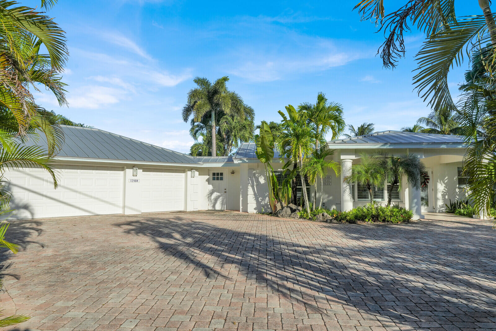 12980 Prosperity Farms Road Palm Beach Gardens, FL 33410 - Photo 5 of 55 a front view of a house with a yard