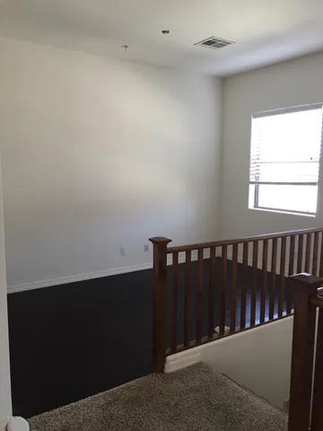 a bathroom with a granite countertop toilet a sink and mirror