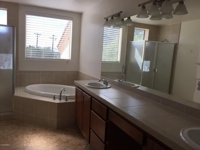 a view of an empty room and wooden floor