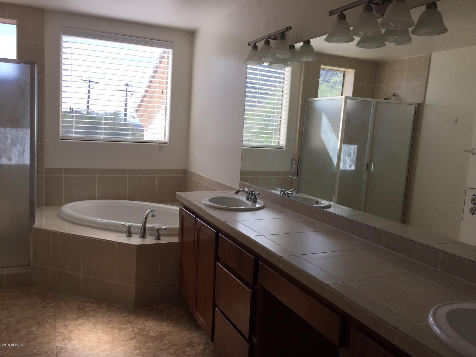 1502 East Dunlap Avenue, Unit 12 Phoenix, AZ 85020 - Photo 6 of 16 a bathroom with a sink a granite counter and a window