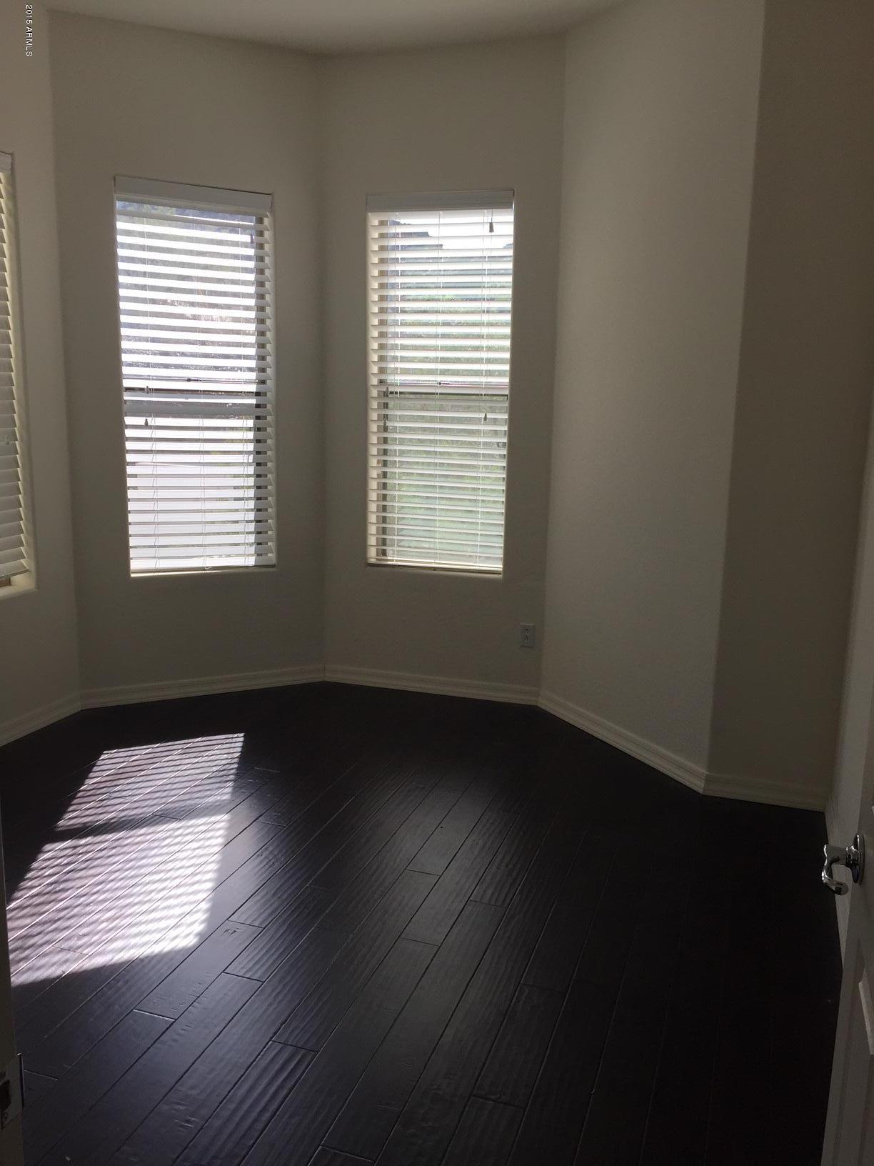 1502 East Dunlap Avenue, Unit 12 Phoenix, AZ 85020 - Photo 7 of 16 a view of an empty room and wooden floor