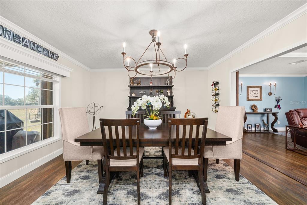 15405 Old Parker Island Road Lake Placid, FL 33852 - Photo 12 of 39 a view of a dining room with furniture window and wooden floor