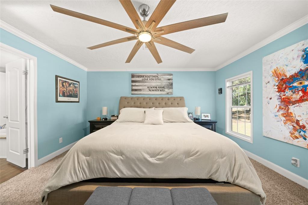 15405 Old Parker Island Road Lake Placid, FL 33852 - Photo 13 of 39 a bedroom with a bed and painting on the wall