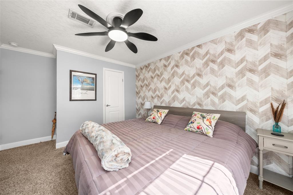 15405 Old Parker Island Road Lake Placid, FL 33852 - Photo 18 of 39 a bedroom with bed and a chandelier