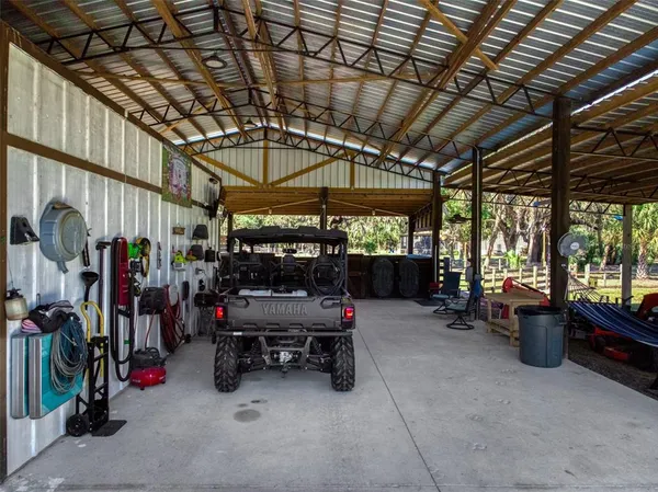 a view of backyard with car parked