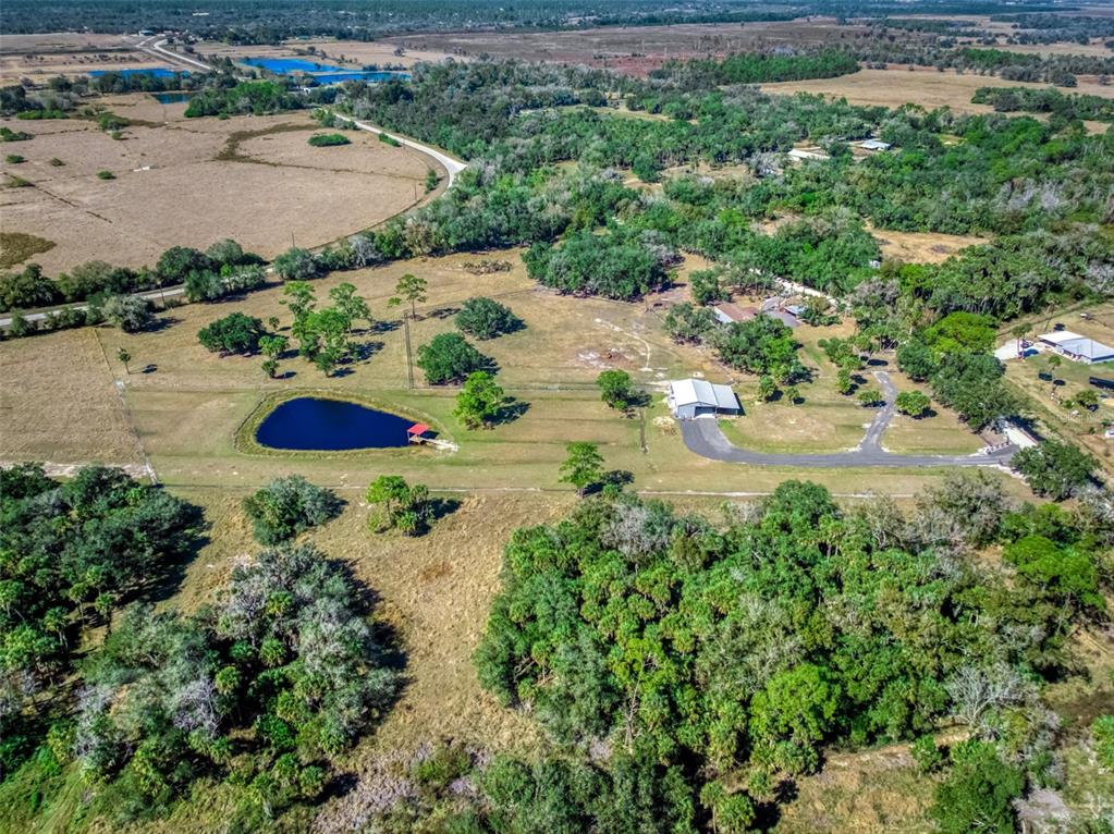 15405 Old Parker Island Road Lake Placid, FL 33852 - Photo 34 of 39 an aerial view of a house with a yard and lake view