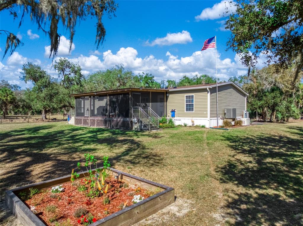 15405 Old Parker Island Road Lake Placid, FL 33852 - Photo 4 of 39 a view of a backyard with a garden
