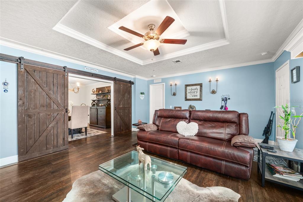 15405 Old Parker Island Road Lake Placid, FL 33852 - Photo 8 of 39 a living room with furniture and a chandelier