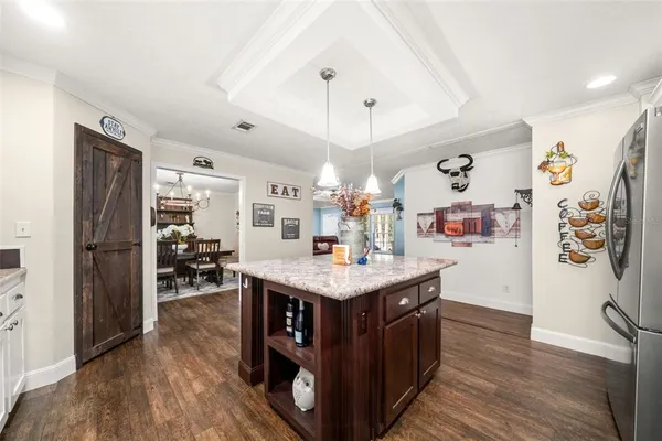 a kitchen with stainless steel appliances granite countertop a refrigerator a sink dishwasher a stove and a refrigerator
