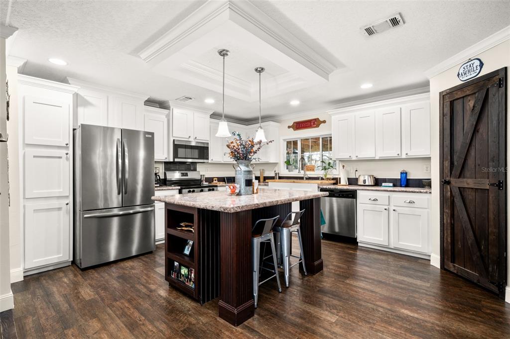15405 Old Parker Island Road Lake Placid, FL 33852 - Photo 10 of 39 a kitchen with stainless steel appliances granite countertop a refrigerator a sink dishwasher a stove and a refrigerator