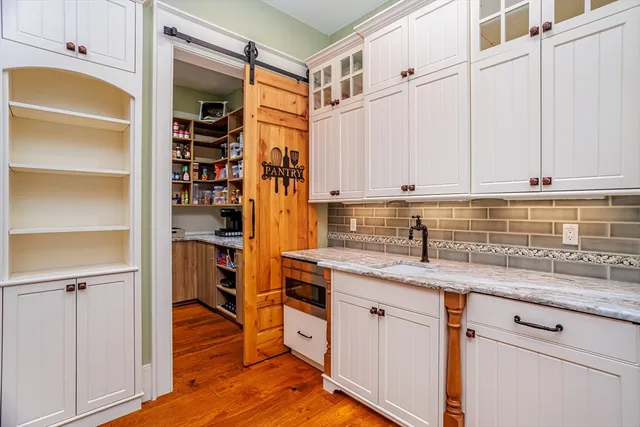 a kitchen with stainless steel appliances granite countertop a sink and cabinets