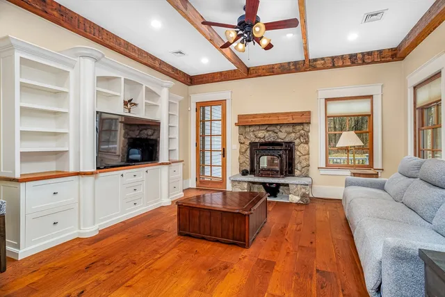 a living room with furniture fireplace and flat screen tv
