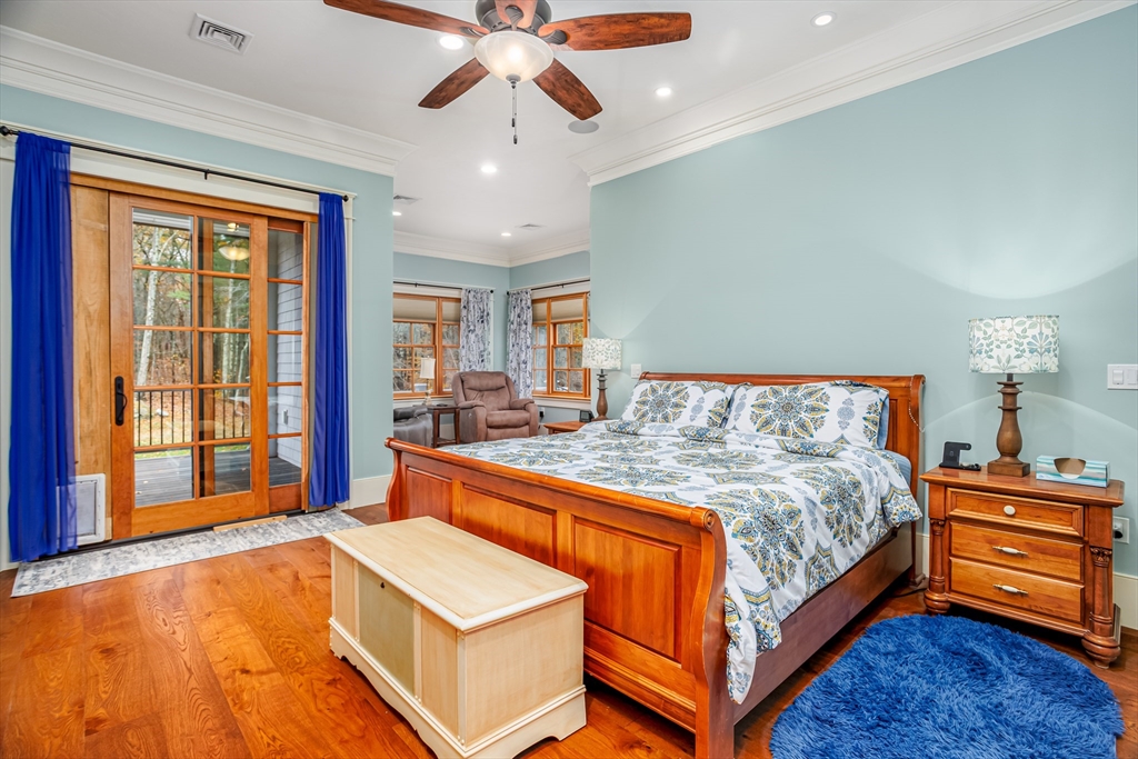 210 Indian Hill Road Groton, MA 01450 - Photo 16 of 42 a bedroom with a bed and a chandelier