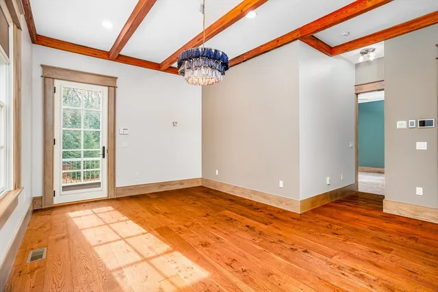 a view of a room with wooden floor and a window