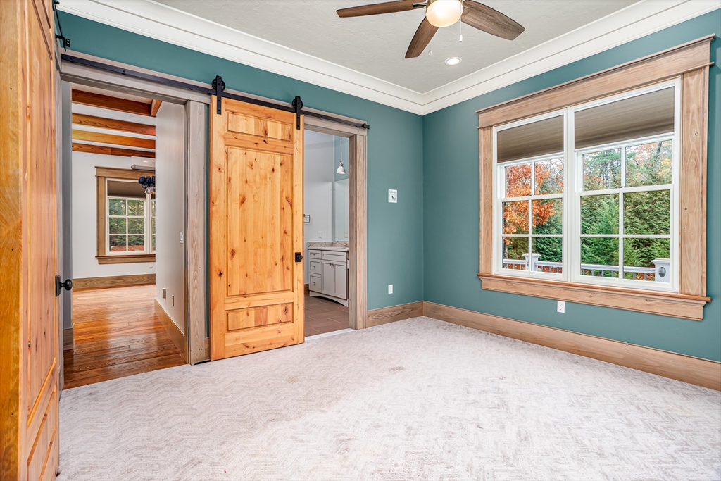 210 Indian Hill Road Groton, MA 01450 - Photo 20 of 42 a view of a livingroom with a chandelier fan and windows