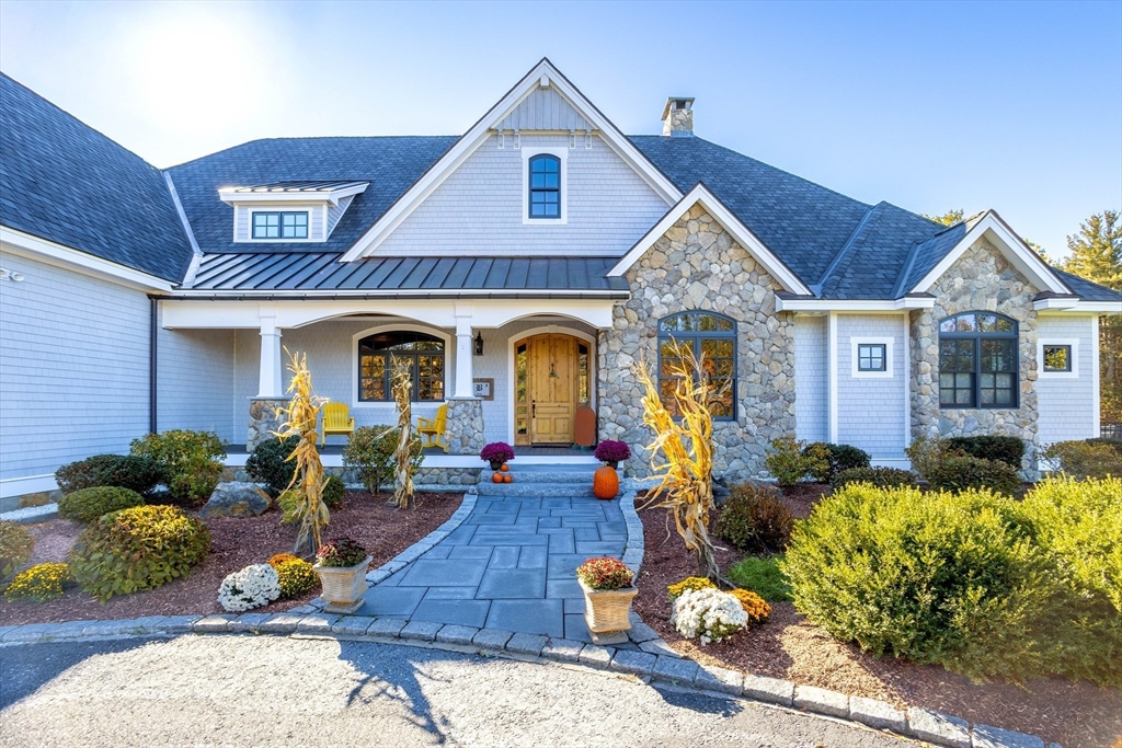 210 Indian Hill Road Groton, MA 01450 - Photo 2 of 42 a front view of a house with lots of potted plants
