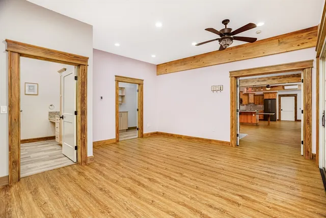 a view of a hallway view with wooden floor and staircase