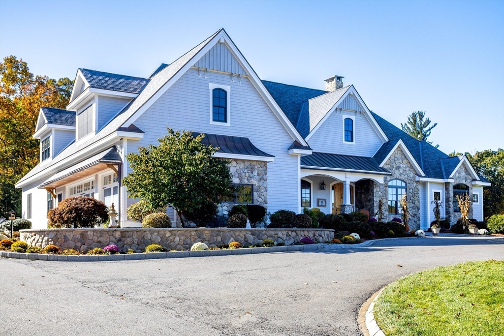 210 Indian Hill Road Groton, MA 01450 - Photo 3 of 42 a front view of a house with a yard and garage