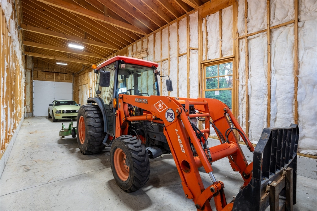 210 Indian Hill Road Groton, MA 01450 - Photo 37 of 42 a bed room with a bed and a chandelier