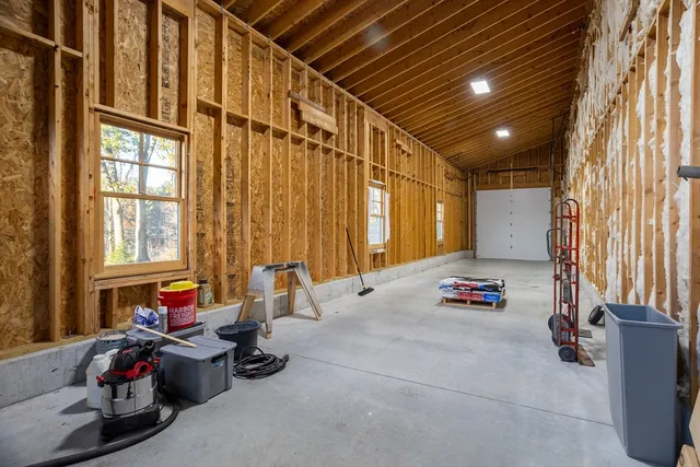 a bedroom with furniture and a large window