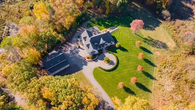 a aerial view of a swimming pool with outdoor seating