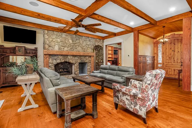 a living room with furniture a flat screen tv and a fireplace