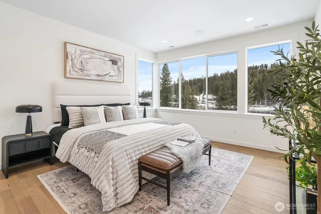 a bedroom with a large bed and a large window