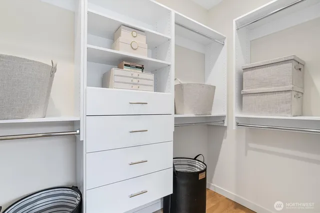 a view of walk in closet with empty racks