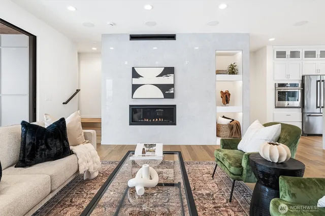 a living room with furniture and wooden floor