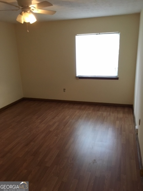 317 Epps Bridge Road Athens, GA 30606 - Photo 5 of 5 an empty room with wooden floor and windows