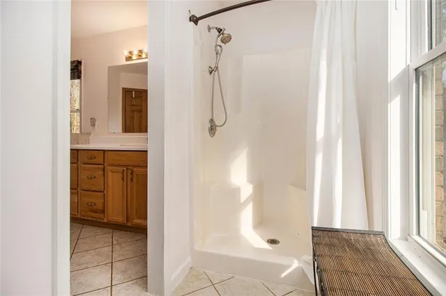 a living room with furniture and a floor to ceiling window