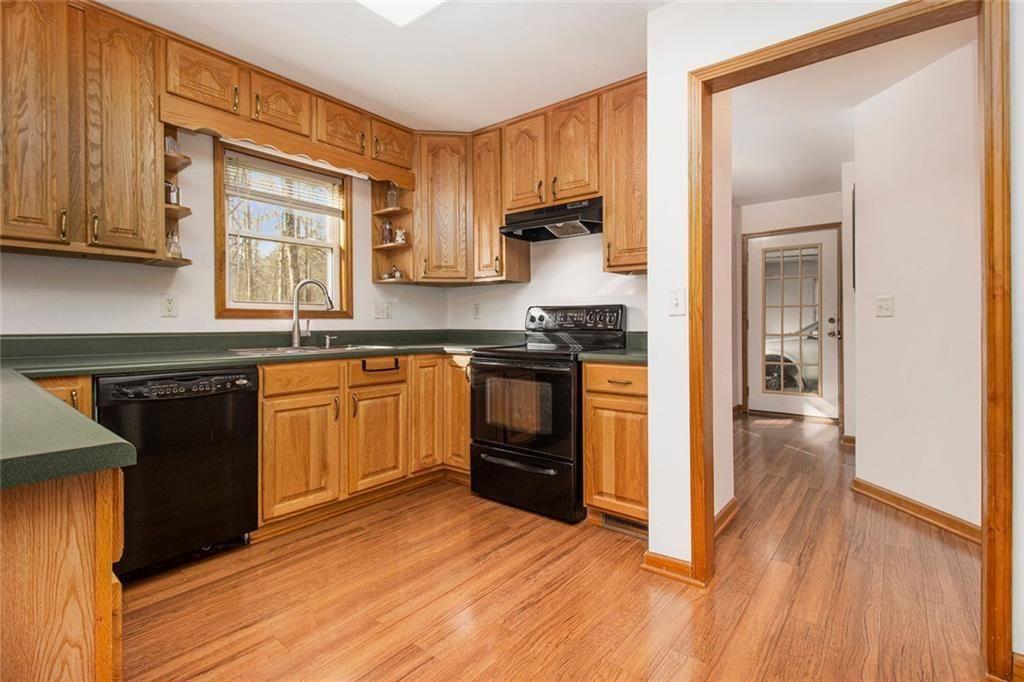 490 Dorsey Road Hampton, GA 30228 - Photo 10 of 63 a kitchen with wooden floors and white appliances