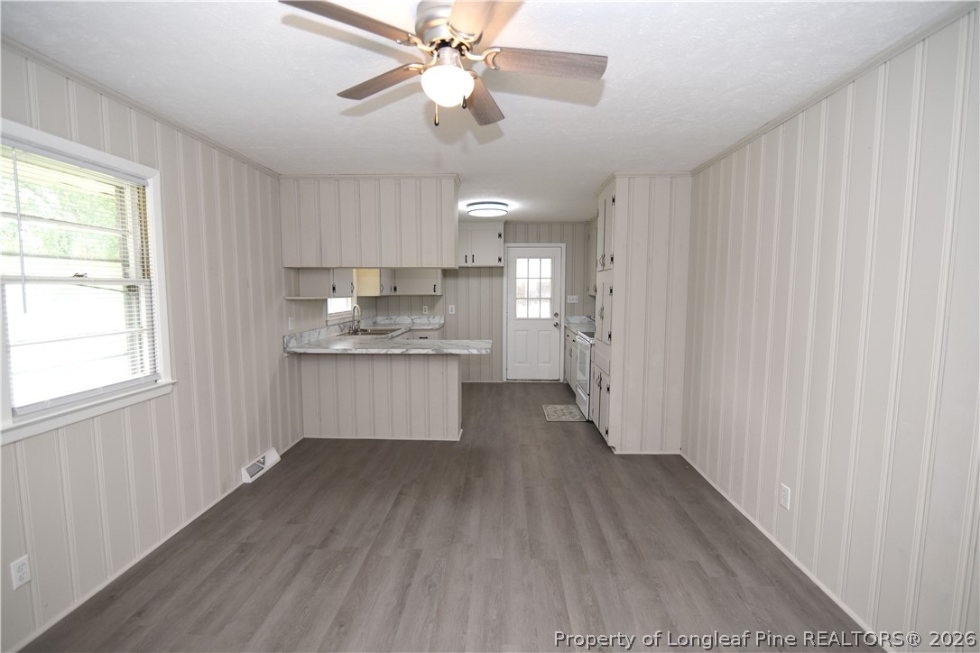 1673 Norment Road Lumberton, NC 28360 - Photo 9 of 32 a kitchen with stainless steel appliances kitchen island hardwood floor and a window