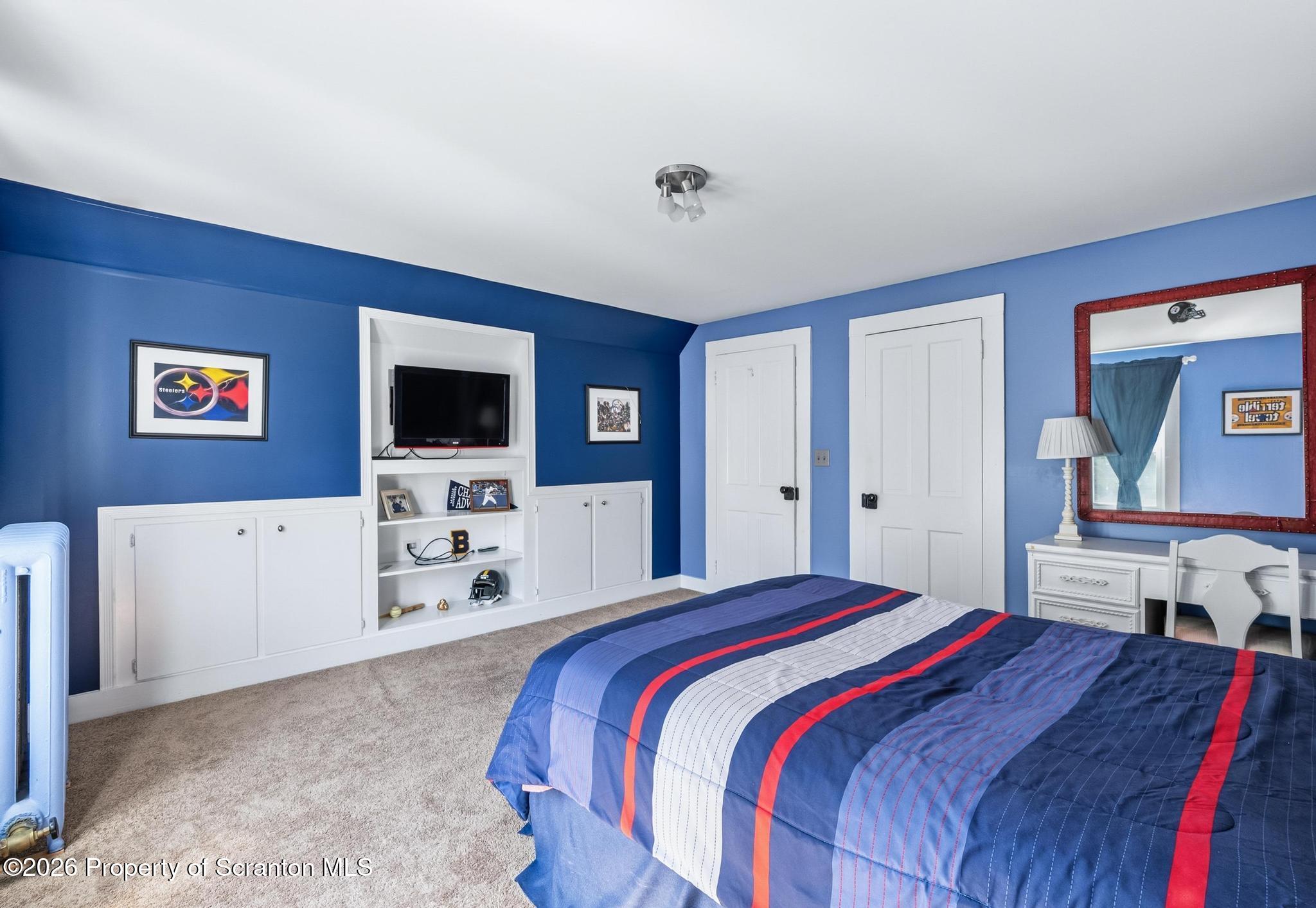 616 Myrtle Street Scranton, PA 18510 - Photo 39 of 65 a bedroom with a bed and a flat screen tv