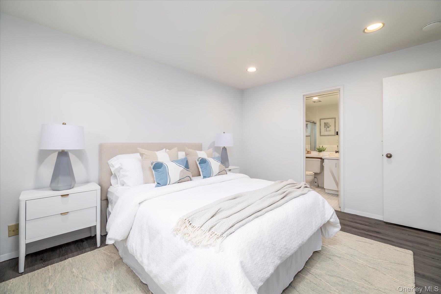 2 Richmond Road, Unit 4A Lido Beach, NY 11561 - Photo 12 of 33 a bedroom with a bed and a night stand