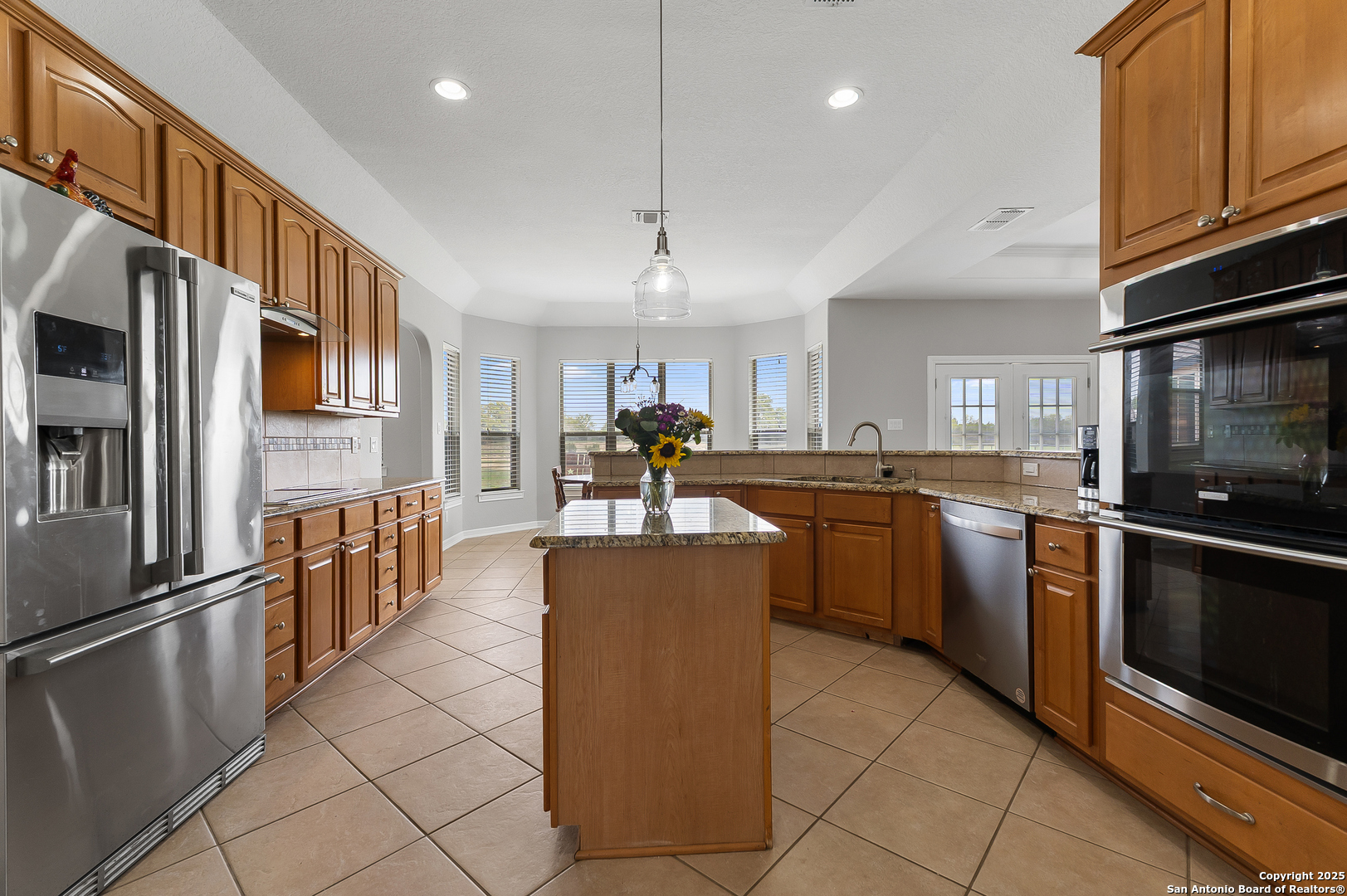 701 Kreutzberg Road Boerne, TX 78006 - Photo 13 of 43 a kitchen with stainless steel appliances granite countertop a refrigerator a stove top oven and a sink