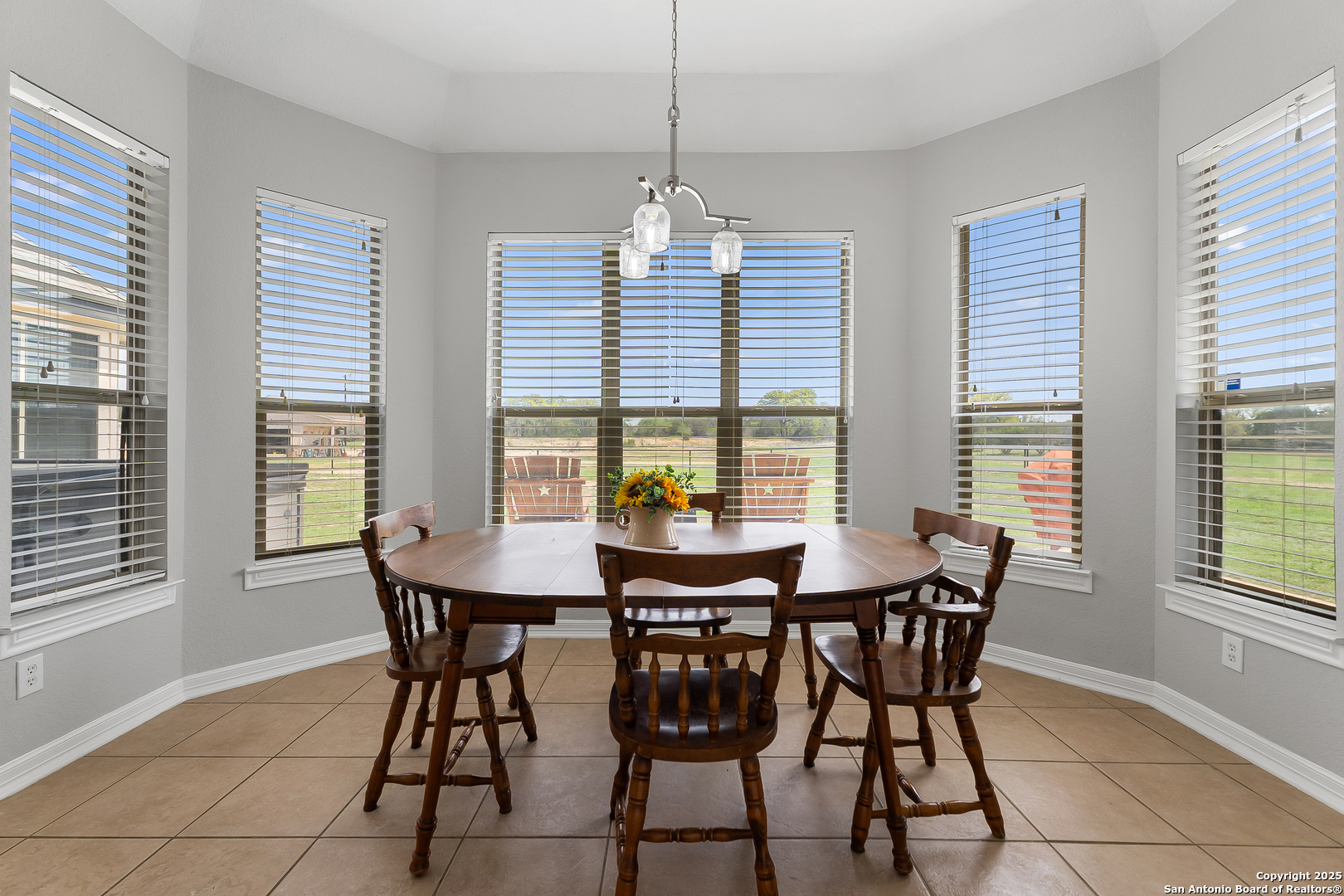 701 Kreutzberg Road Boerne, TX 78006 - Photo 15 of 43 a view of a dining room with furniture and windows