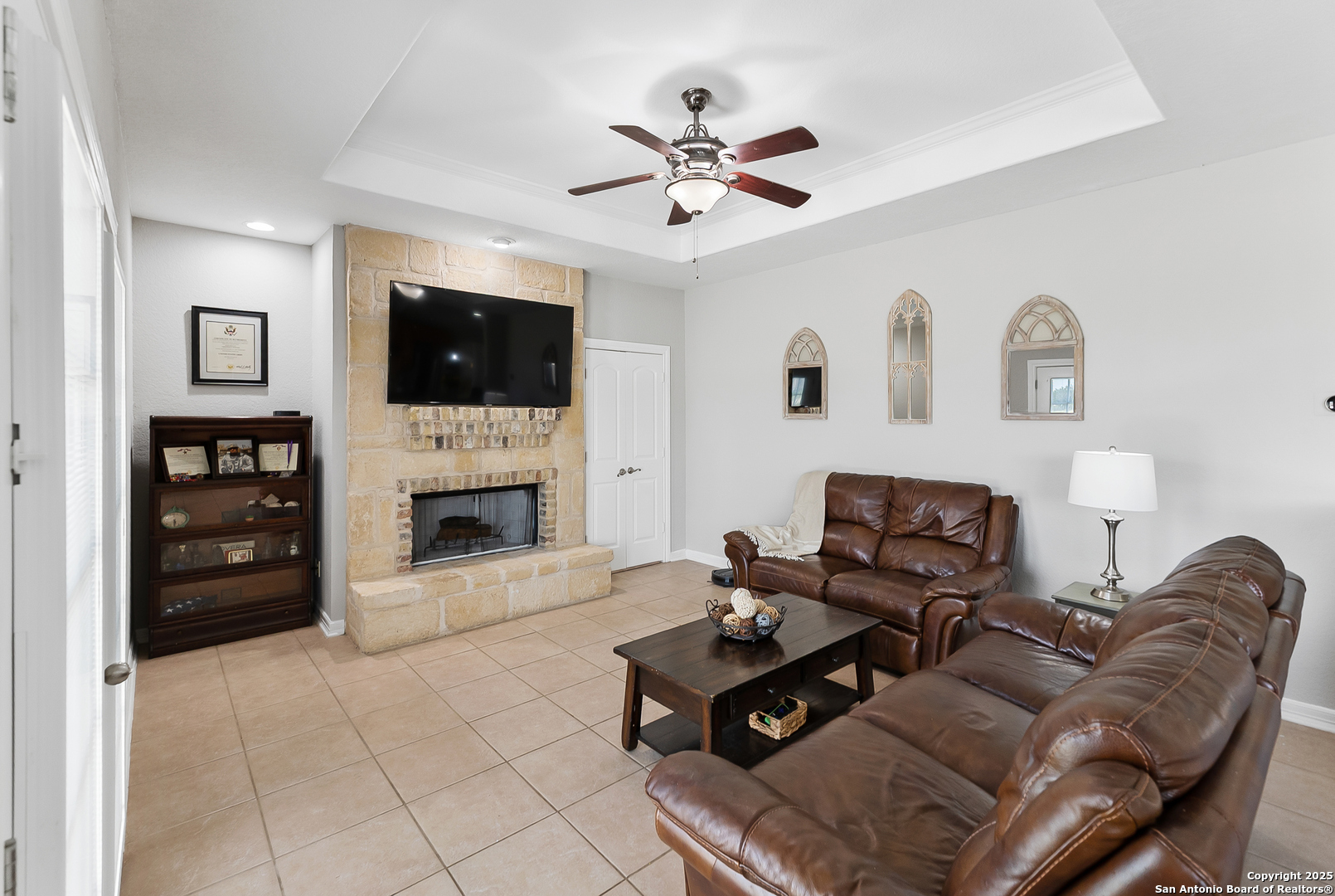 701 Kreutzberg Road Boerne, TX 78006 - Photo 19 of 43 a living room with furniture a flat screen tv and a fireplace