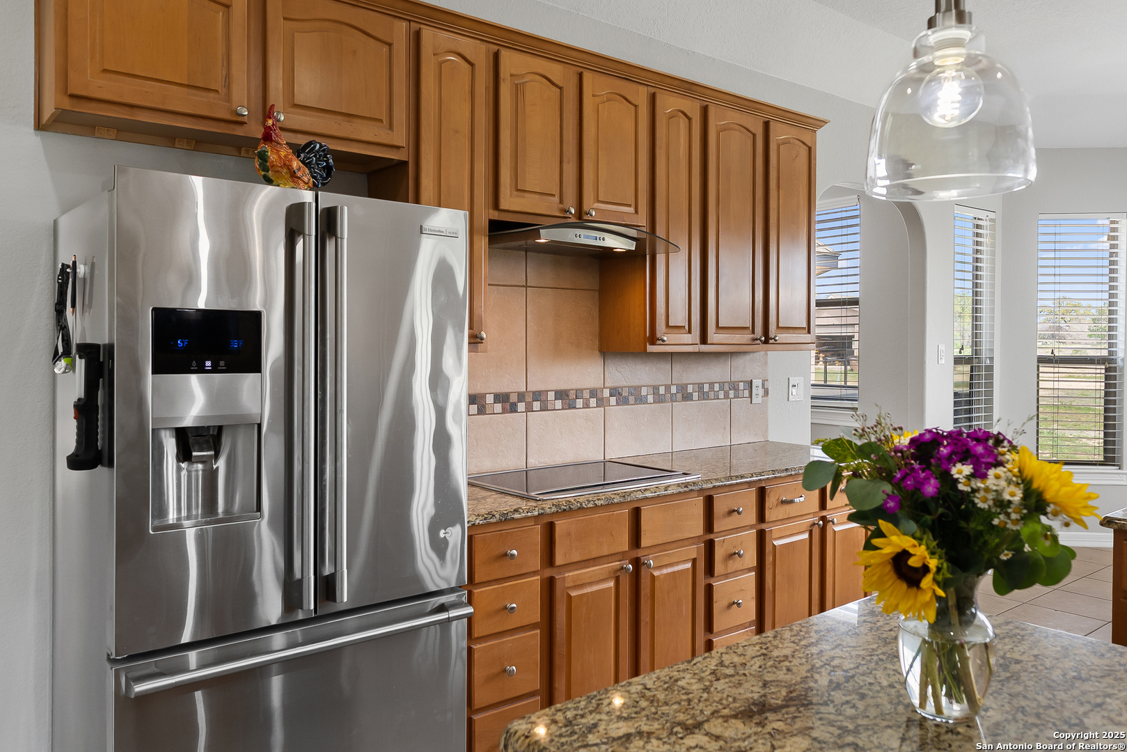 701 Kreutzberg Road Boerne, TX 78006 - Photo 9 of 43 a kitchen with stainless steel appliances granite countertop a refrigerator and a sink