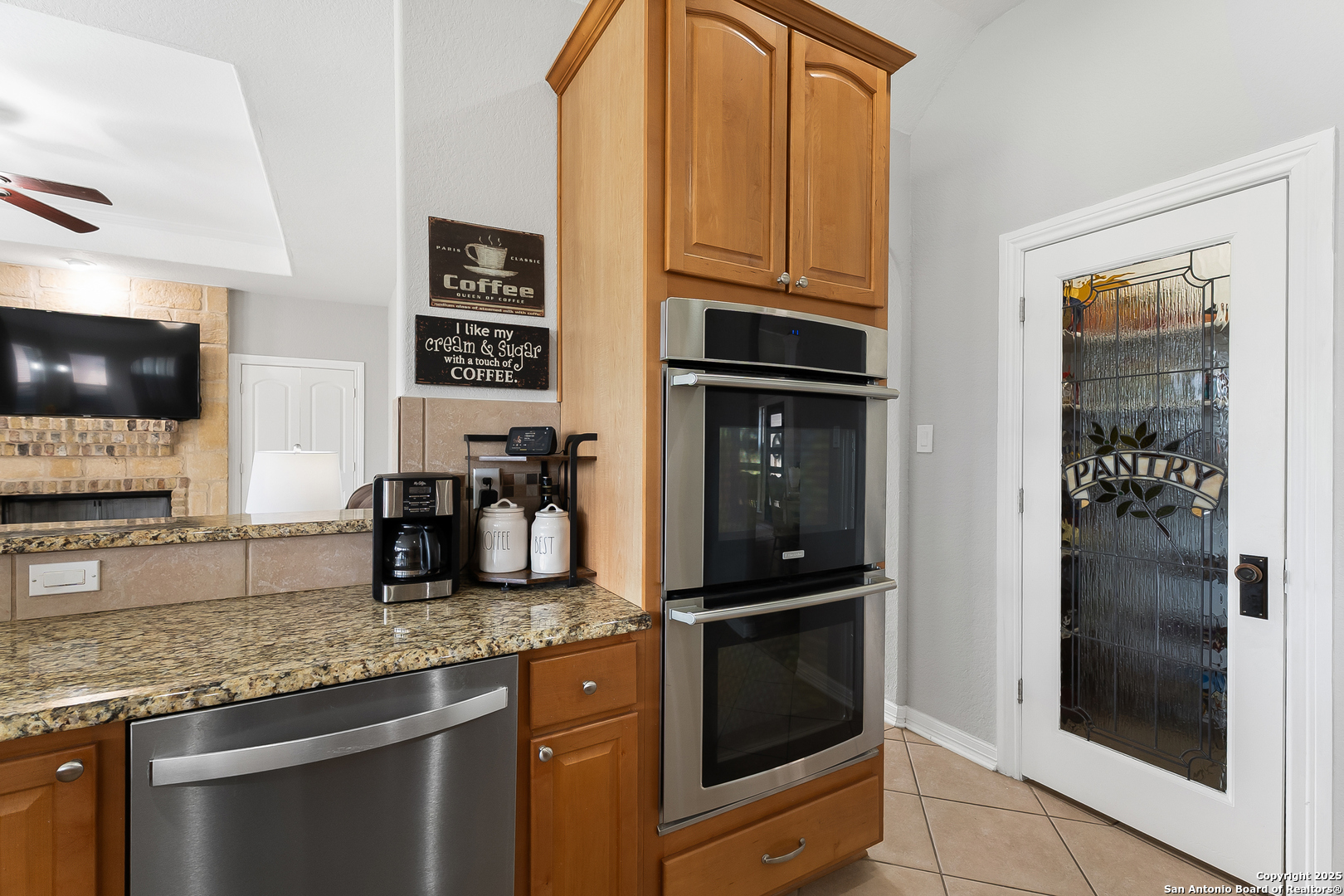 701 Kreutzberg Road Boerne, TX 78006 - Photo 10 of 43 a kitchen with granite countertop a refrigerator and a sink