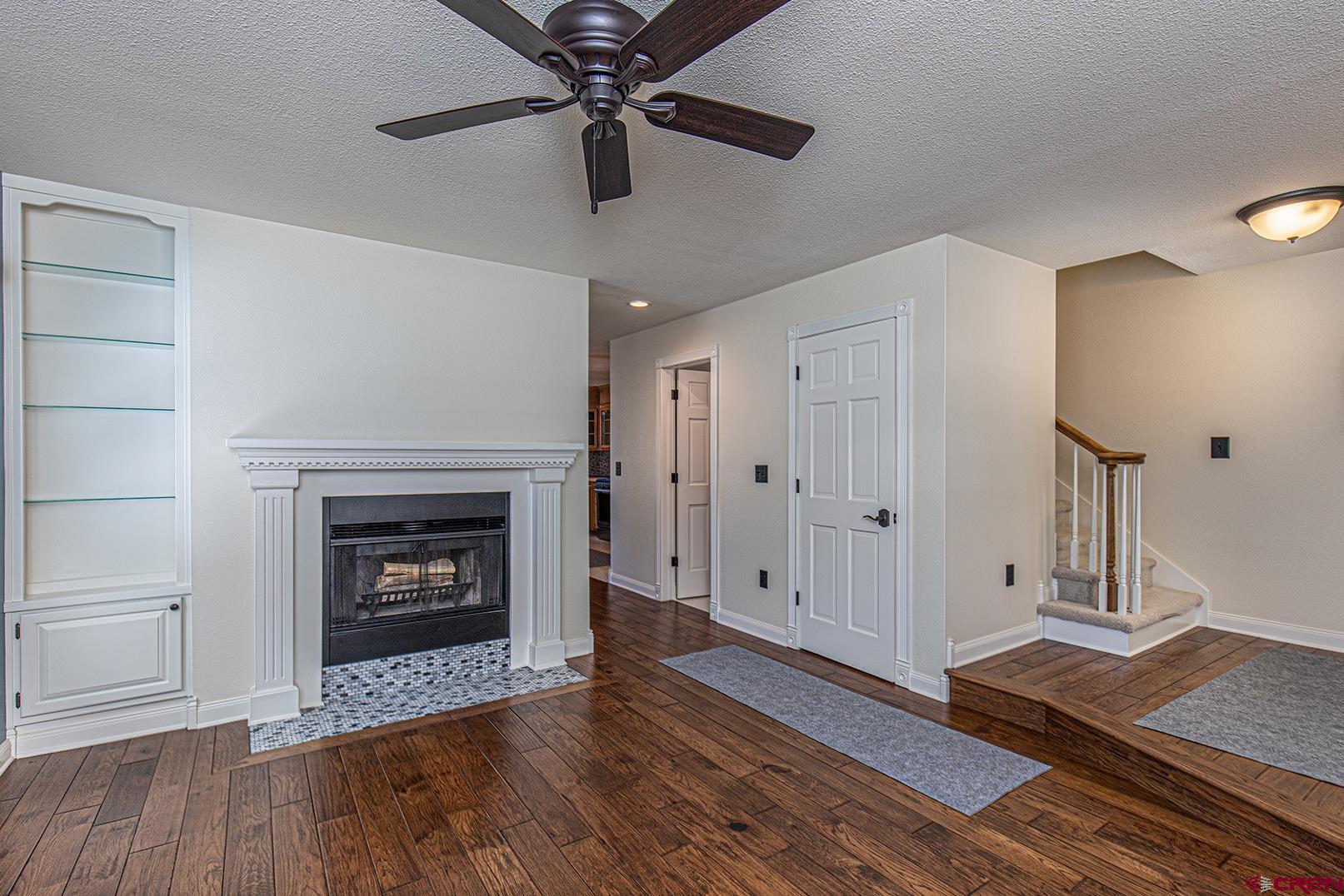 130 Hidden Treasure, Unit 1 Durango, CO 81301 - Photo 12 of 32 a view of a livingroom with wooden floor and a fireplace