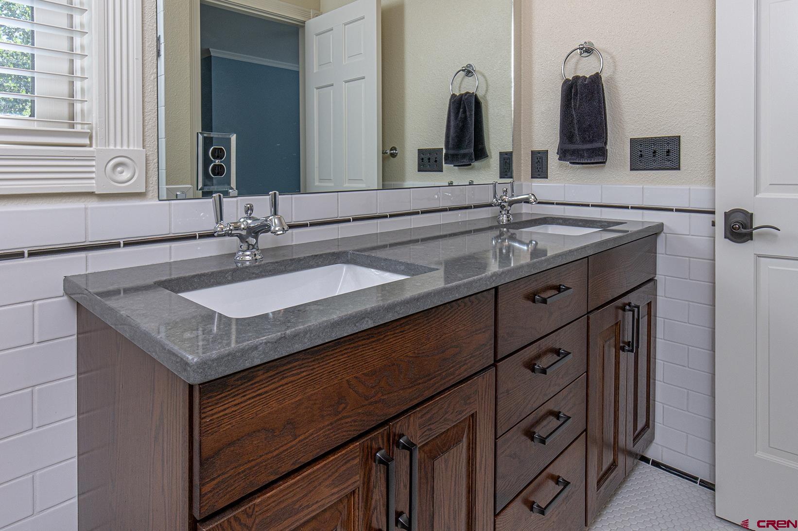 130 Hidden Treasure, Unit 1 Durango, CO 81301 - Photo 17 of 32 a bathroom with a sink and a mirror