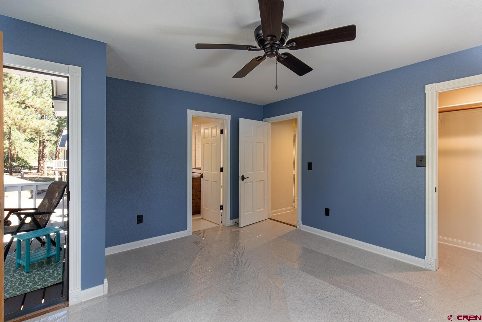 130 Hidden Treasure, Unit 1 Durango, CO 81301 - Photo 21 of 32 an empty room with ceiling fan and window