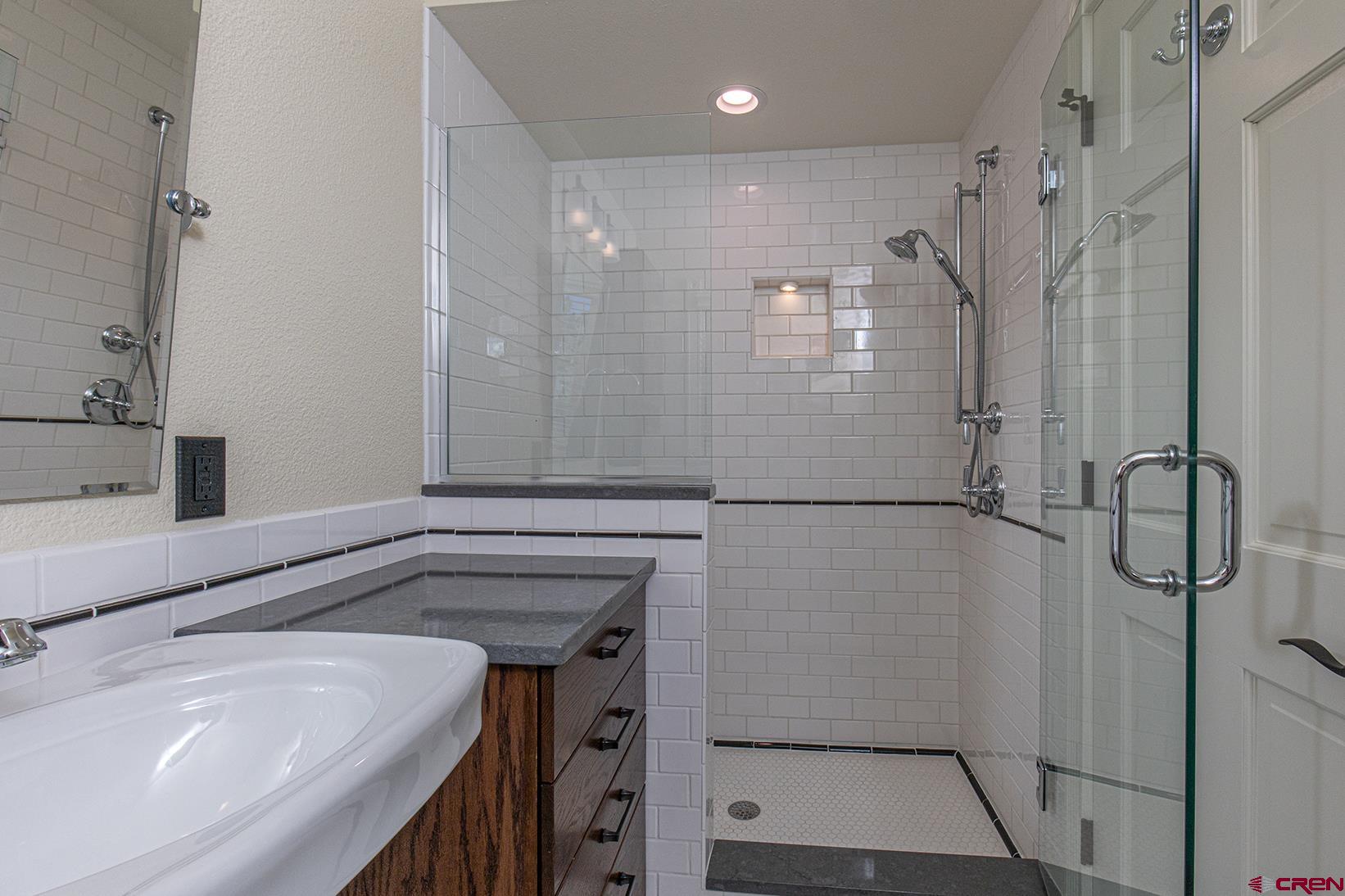 130 Hidden Treasure, Unit 1 Durango, CO 81301 - Photo 23 of 32 a bathroom with a shower and a sink