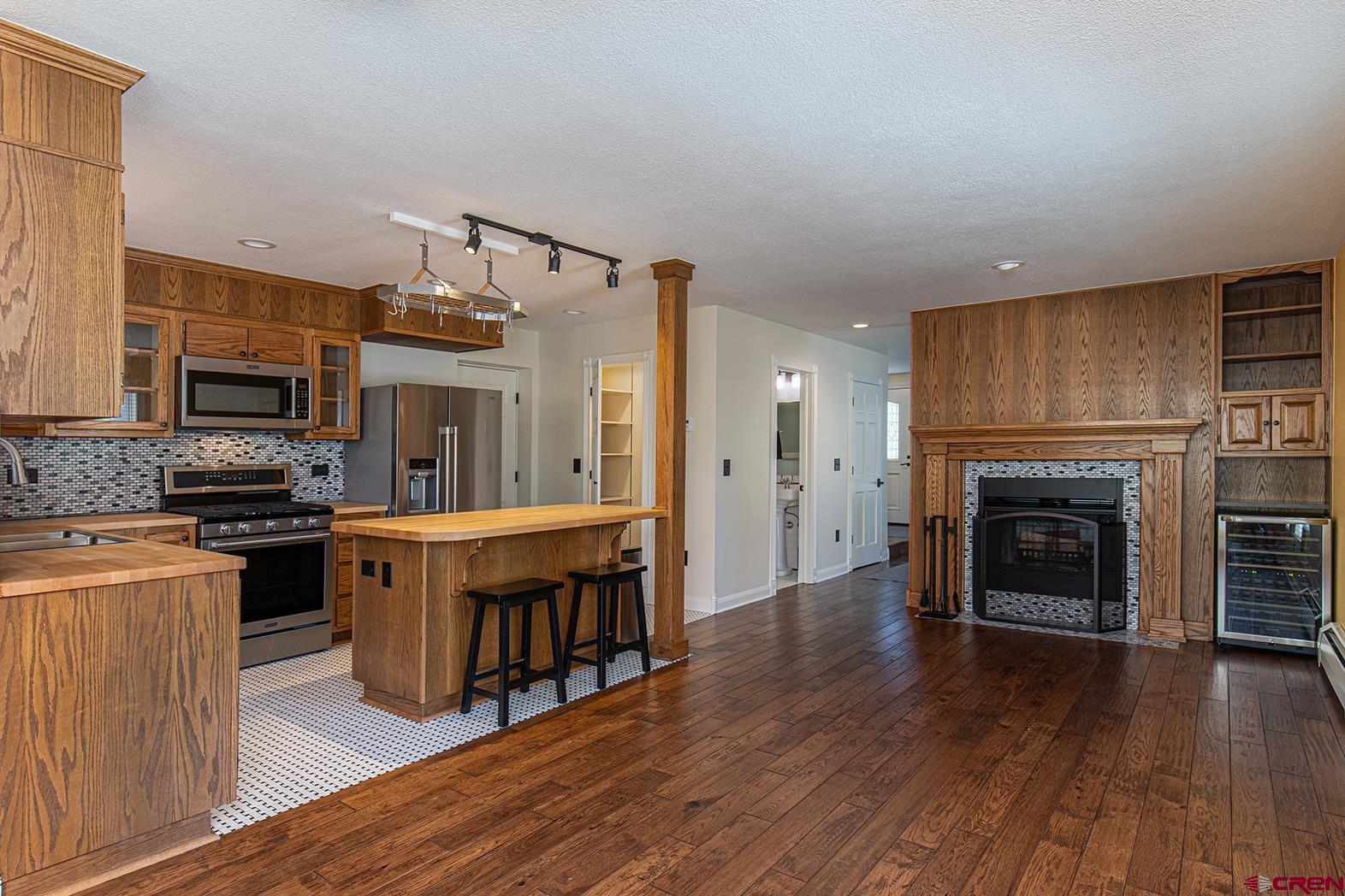 130 Hidden Treasure, Unit 1 Durango, CO 81301 - Photo 6 of 32 a kitchen with stainless steel appliances a stove top oven a sink and a refrigerator