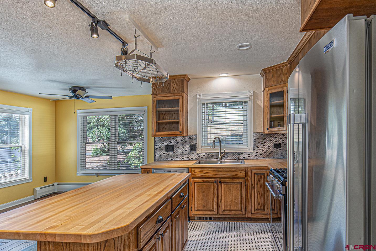 130 Hidden Treasure, Unit 1 Durango, CO 81301 - Photo 9 of 32 a room with stainless steel appliances kitchen island granite countertop a sink and cabinets